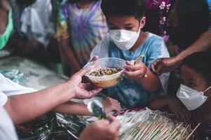 ChiangMai Thailand  October 23 2022 Starving Asian children are begging for free food from volunteers. photo