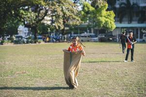 ChiangMai Thailand  November 30 2022  Asian teenage students are doing a sack race for unity in Chiang Mai Rajabhat University photo