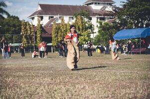 ChiangMai Thailand  November 30 2022  Asian teenage students are doing a sack race for unity in Chiang Mai Rajabhat University photo