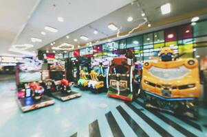 Blurred image of amusement park, children's rides in shopping mall. photo