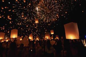 Chiang Mai - Thailand November 27, 2023  Tourists happily celebrate releasing lanterns at the Loi Krathong Yi Peng Lantern Festival according to Thai cultural traditions. photo