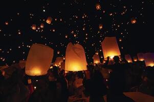 Chiang Mai - Thailand November 27, 2023  Tourists happily celebrate releasing lanterns at the Loi Krathong Yi Peng Lantern Festival according to Thai cultural traditions. photo