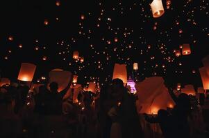 Chiang Mai - Thailand November 27, 2023  Tourists happily celebrate releasing lanterns at the Loi Krathong Yi Peng Lantern Festival according to Thai cultural traditions. photo