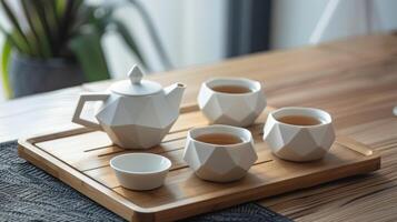 A modern and minimalist ceramic tea set with a sleek matte white finish and geometric shapes perfect for trendy tea lovers. photo