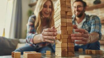 A game of Jenga is set up on a coffee table the couple laughing as they carefully remove pieces with steady hands photo
