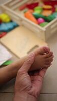 Father's hand holding child's foot slow motion video