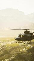 slow motion Vietnam War era helicopter in mountains video