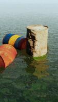 old rusty oil barrels in the sea video