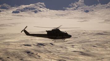 A helicopter flying through the sky over a mountain range video