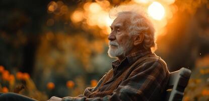 A whitehaired gentleman sitting in quiet contemplation on a bench in his backyard the rising sun creating a warm glow on his serene expression photo