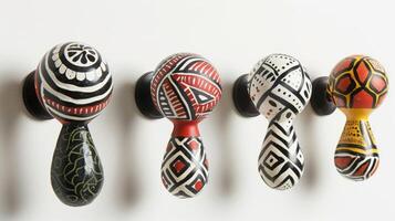 A set of handpainted ceramic coat hooks inspired by traditional tribal patterns adding a unique touch of culture to any space. photo