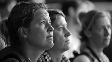 Visitors take a moment to study a striking black and white photograph its subject matter open to interpretation photo