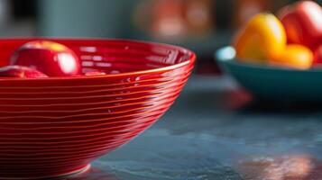 A vibrant red ceramic fruit bowl with a glossy finish and a modern circular design. photo