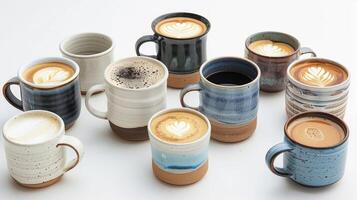 An assortment of handmade ceramic mugs and cups each holding a different type of artisan coffee photo