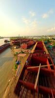 Industrial shipyard constructing large barges along the river canal in Vietnam video