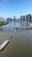 Aerial of barge on the Saigon River and Ho Chi Minh City skyline, Vietnam video