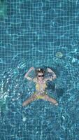 Caucasian woman swimming on the back in the pool in slow motion. video