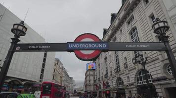 London, United Kingdom - April 2, 2024 - Piccadilly Circus Scene underground sign in London, Red London phone booth, busses and people video