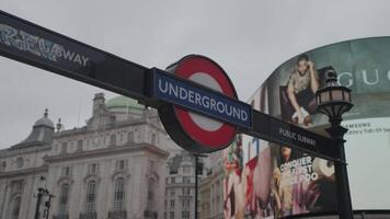 London, United Kingdom - April 2, 2024 - Piccadilly Circus Scene underground sign in London, Red London phone booth, busses and people video