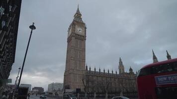 London, United Kingdom - April 2, 2024 - Big Ben Houses of Parliament the Palace of Westminster, and iconic AEC Routemaster red double-decker buses video