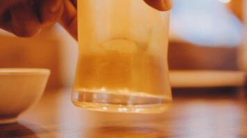 close up of cold mug of beer in a bar on a wooden table video