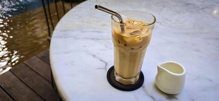 Fresh iced coffee in glass with frothy cream for your design, Food concept in style, copy space photo