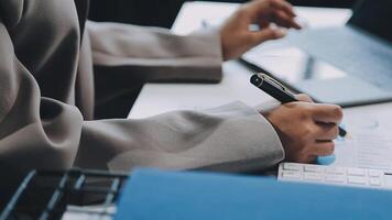 Co working conference, Business team meeting present, investor colleagues discussing new plan financial graph data on office table with laptop and calculator, Finance, accounting, investment. video