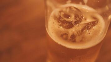 close up of cold mug of beer in a bar on a wooden table video
