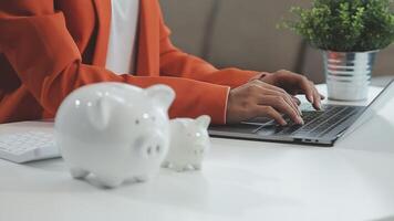 woman hand putting money coin into piggy for saving money wealth and financial concept. video