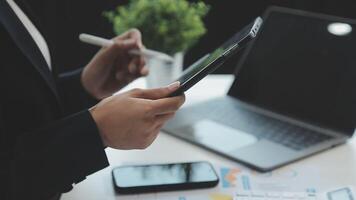 Co working conference, Business team meeting present, investor colleagues discussing new plan financial graph data on office table with laptop and calculator, Finance, accounting, investment. video