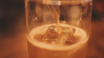 close up of cold mug of beer in a bar on a wooden table video