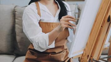 plus de le épaule sélectif concentrer coup de Masculin artiste en utilisant brosse tandis que ajouter Couleur peindre à crayon dessin sur Toile video