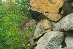 Large pile of stones. Stone rocks. Granite quarry. Abandoned industrial production. photo