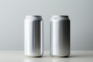 Two aluminum soda cans lined up next to each other on a flat surface. photo
