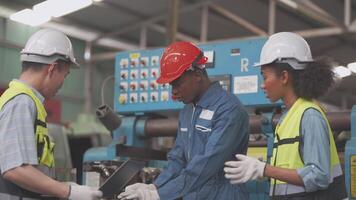 fábrica profesional africano y asiático trabajador y gerente inspector en máquina y discutir inspección alrededor fábrica. equipo ingenieros reparando para calidad y puesta en marcha pruebas antes de operación. video