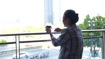 asiatisk senior gammal kvinna är dricka kaffe och gående runt om utomhus- fotgängare. video