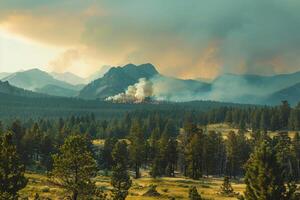 Smoke billowing up over a mountain range, visible signs of a distant wildfire impacting the landscape photo