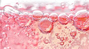 Close up of pink wine bubbles in a glass, macro shot, isolated on white background photo