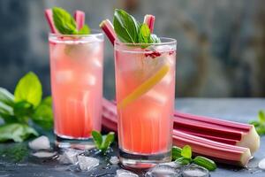 Refreshing rhubarb cocktails with basil garnish on a wet slate surface, perfect for spring celebrations or summer refreshments photo