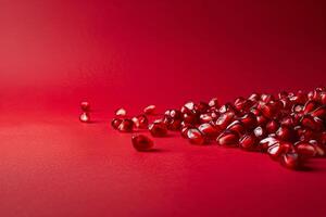 scattered pomegranate seeds isolated on a red gradient background photo