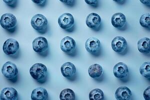 Faded blueberries arranged in a sparse pattern, muted blue tones on a clean background photo