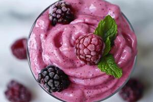 Close up of a berry smoothie with a swirl of yogurt, top view, fresh ingredients visible photo