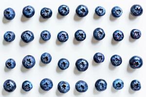 Abstract arrangement of blueberries forming a simple geometric pattern, isolated on white photo