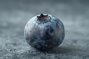 Macro shot of a blueberry with visible texture, isolated on a grey background photo