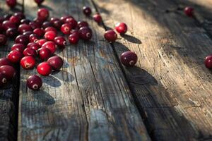 Cranberries scattered on a rustic wooden surface, natural autumn light casting soft shadows photo