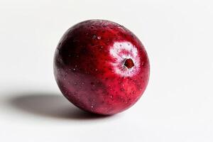 Single cranberry isolated on a bright white background, high contrast minimalist shot photo