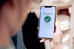 Payment complete Notifications. Customer using online banking application on smartphone to pay for purchases online and product in department store photo