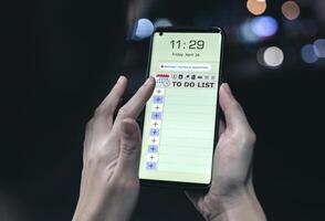 Reminder list concept. Woman uses smartphone application to record to-do list and reminders of important schedules, meeting appointments photo