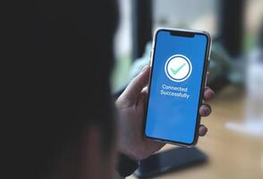 Businessman using smartphone for connect successfully to network signal. Concept of digital data exchange technology, remote control system connection photo