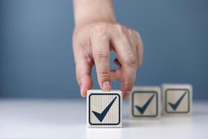 Inspection and certification of standards. Check mark on wooden block photo